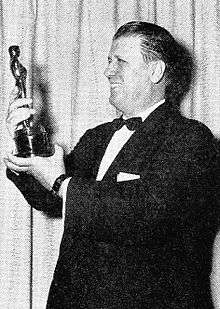 George Stevens holding his Oscar for Giant.