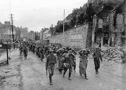 German prisoners of war escorted by American soldiers in Cherbourg in 1944.