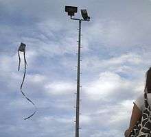 Kite flying in the Philippines, against a gray sky