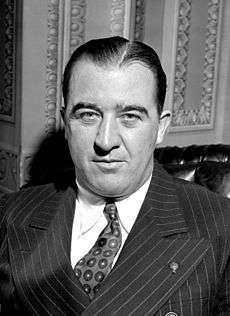 A black-and-white photo of a man in his fifties wearing a suit