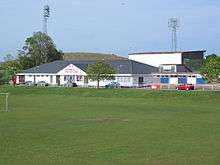 Soccer field with low, pitched-roof building in background