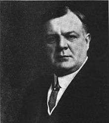 middle-aged man in business suit in full profile photograph