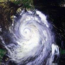 A large hurricane with a well-defined eye in the Gulf of Mexico. Cuba is mostly obscured; Florida can be seen in the top of the image; the Yucatán Peninsula is in the bottom left.