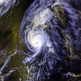 A view of Hurricane Iniki from Space on September 11, 1992. The storm is situated over the Hawaiian Islands, and is surrounded by open waters of the Pacific. Iniki's eye, seen near the center of the image, is well-defined, and representative of an intense hurricane.