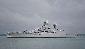 Long, grey ship against a cloudy sky