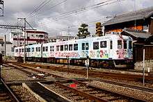 Subway train with cartoon characters and lettering on its side