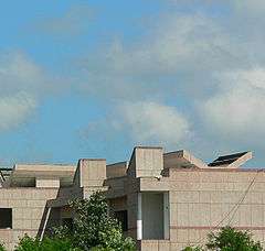 Modern building against a blue sky with clouds