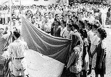 Raising the Indonesian flag in front of the witnesses.