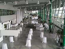 Airport terminal, with small round tables covered with large white tablecloths