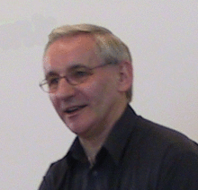 head shot of a man wearing spectacles