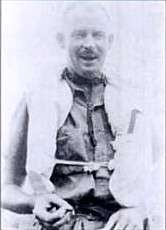 Informal half-portrait of balding man in life jacket and light-coloured shirt