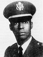 A black and white head shot image of Warren in his military dress uniform with hat.