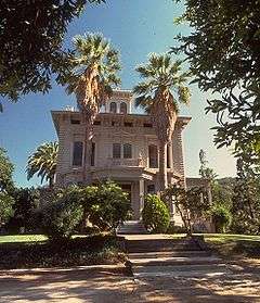 Photograph of the Victorian John Muir House from street level, looking up at the house and its pergola against the sky.