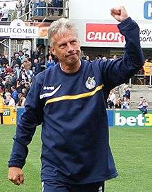 John Ward making a fist while walking on a grass field