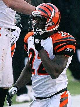  A football player kneeling down on the football field after a tackle