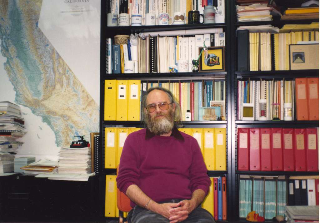 Jon Postel sitting in office.jpg