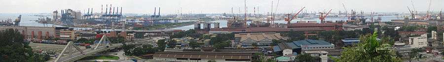 An industrial landscape with buildings and numerous cranes.