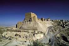 A castle built of stones on a cliff near a settlements