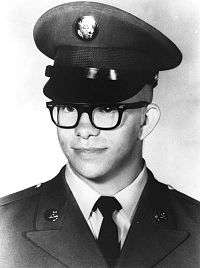 A black and white image showing the head and shoulders of Kaye in his military dress uniform with ribbons and hat.