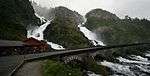 A road bridge across a waterfall