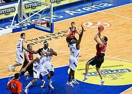 Professional basketball game, with a player preparing to shoot