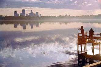 Downtown skyline in view over Lake Calhoun and its dock