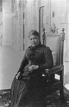 Queen Liliʻuokalani, seated inside ʻIolani Palace.