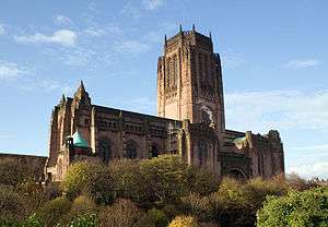 A large building on a hill with a broad central tower