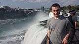 Boy posing for photo with Rainbow Bridge in background