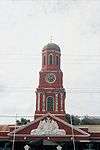 Clock tower of red bricks.