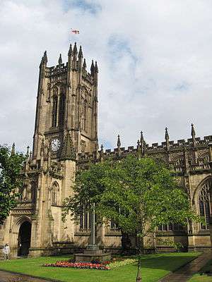 Part of the cathedral showing the west tower, south porch, aisle and clerestory, all with openwork parapets and pinnacles