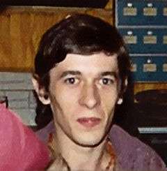 Head and shoulders portrait of a 24 year old man with short brown hair