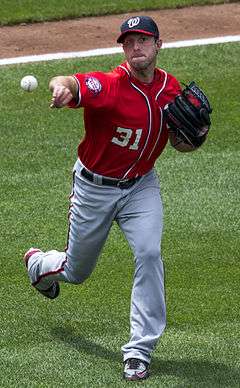 Max Scherzer wearing red shirt number 31, throwing a pitch