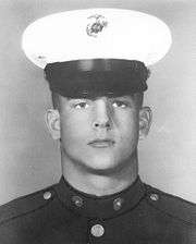 A black and white image of Maxam wearing his military dress blue uniform with hat.