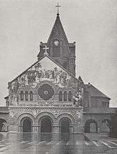 The same church at day, this time with a tower and spire rising to 80-foot (24 m) spire, over its centre.