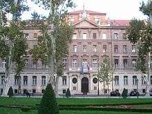 Building in formal style behind scattered trees