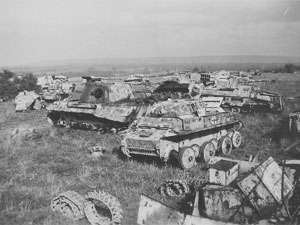 Wrecked vehicles are strewn across a field.