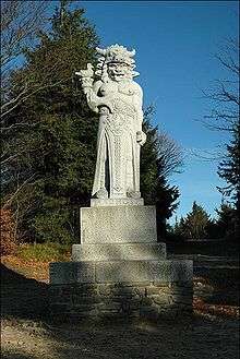 Statue of a fierce-looking god in a park