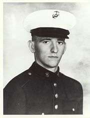 A black-and-white photo of Newlin from the waist up in his military dress blue uniform with hat.