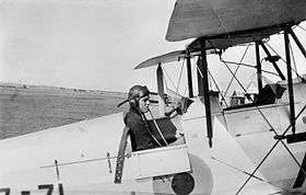 Pilot in biplane cockpit