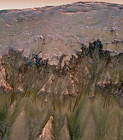 Image from the Mars Reconnaissance Orbiter showing photographic evidence of possible liquid water on Mars.