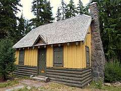 Photograph of a rustic building in a forest