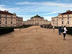 Large symmetrical palace complex with white walls.