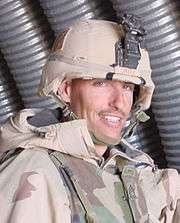 Head and shoulders of smiling man in circa 2000 U.S. Army battle dress.