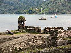 Ruins of a fort near water.