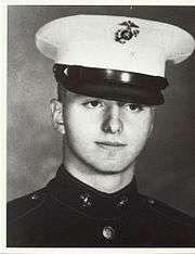 A black and white image showing the head and shoulders of Pless in his Marine Corps dress uniform with hat.