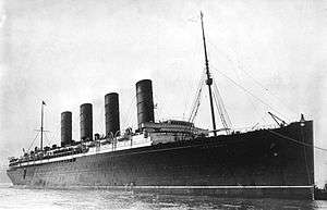 A black-and-white photograph of an ocean liner with four smokestacks.