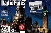 A gatefold magazine cover, depicting a nighttime scene with four gold Daleks in the foreground, the railing of a bridge in the midground, and the Perpendicular Gothic towers of the Houses of Parliament and Big Ben in the background. The left half of the image contains the text "Radio Times" in the top, and "VOTE DALEK!" in the lower left. A small black-and-white photograph is superimposed on the upper left of the right side of the image; that photograph, taken from a slightly different angle, shows four Daleks crossing the same bridge, with the same building in the background.