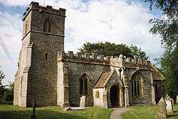 Stone building with square tower.