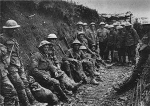 Mud stained British soldiers at rest